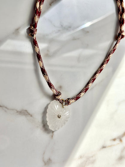 Adjustable paracord heart necklace in burgundy and cream with natural quartz pendant.