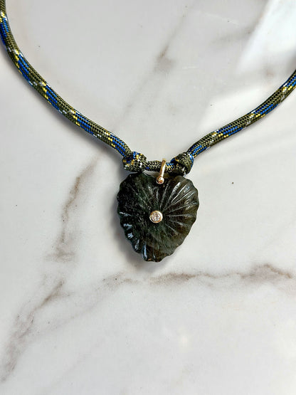 Olive and blue patterned paracord necklace with dark green carved stone pendant and CZ center accent.
