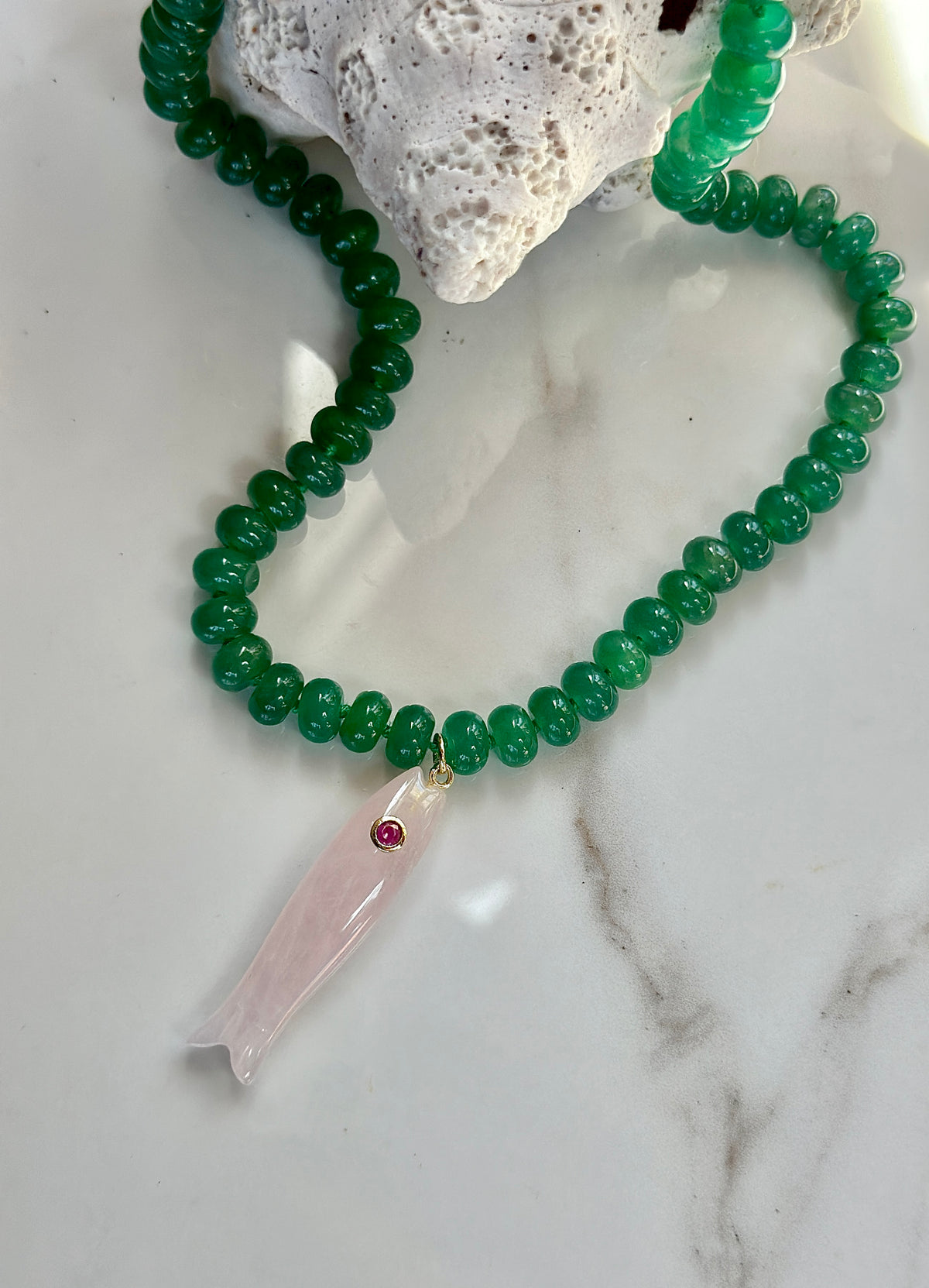 Green gemstone fish necklace with pink carved fish pendant – coastal jewelry.
