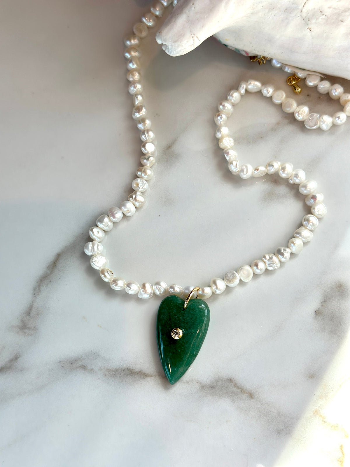 Green gemstone heart and freshwater pearl statement necklace.
