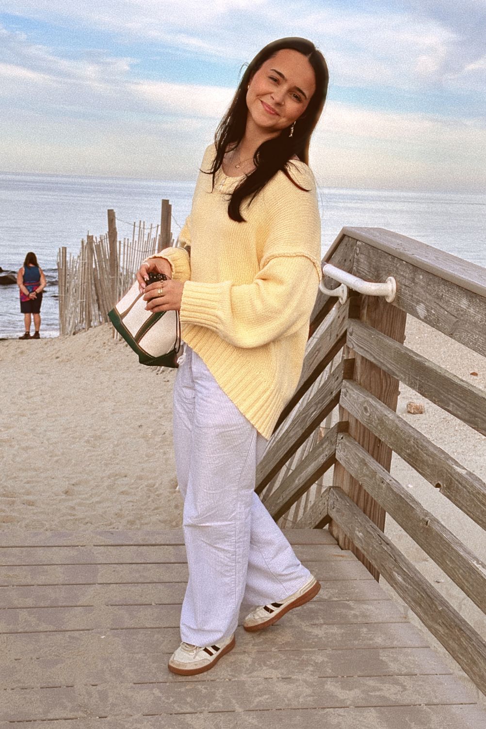 Timeless yellow sweater styled with blue striped pants