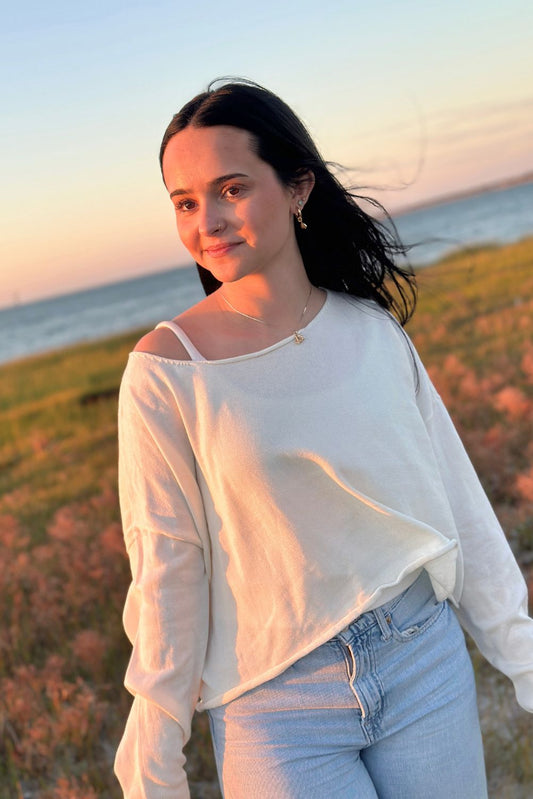 Cream wide boatneck sweater with cropped fit on model